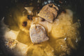 Chamomile and calendula herbal bath bags steeping in golden water