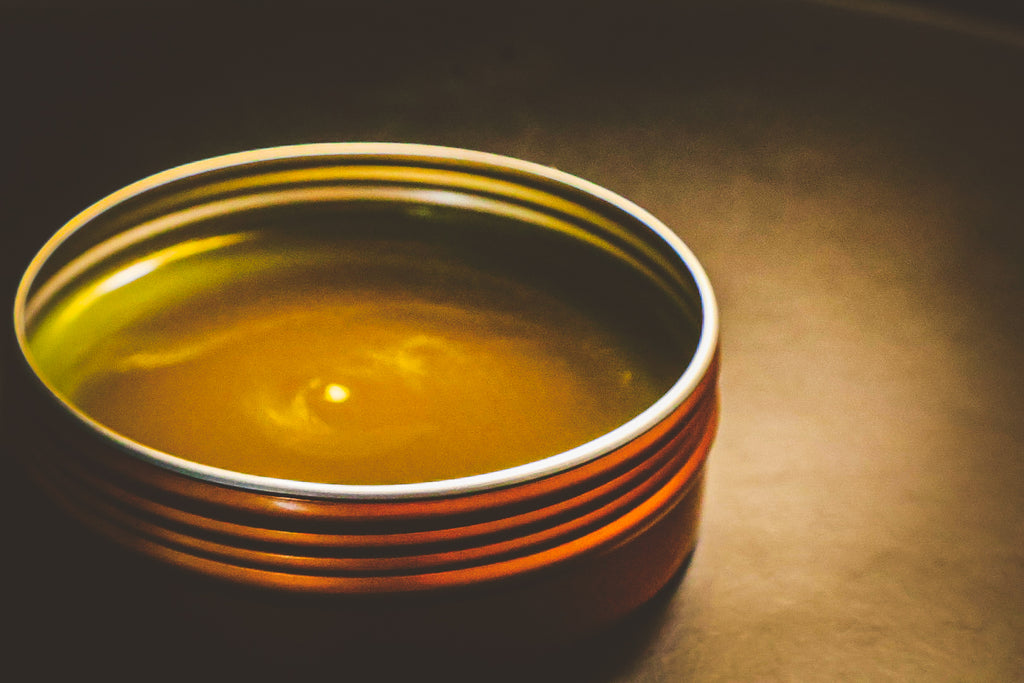 Healing Touch Salve in a copper tin — side view showing rich golden olive oil salve