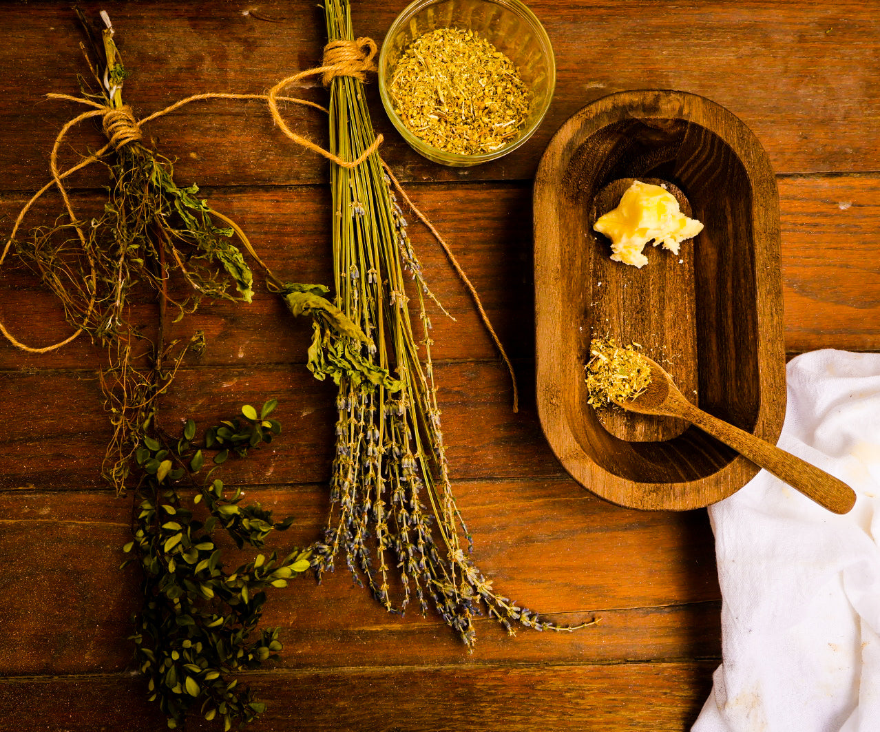 Front Porch Remedy whipped tallow balm with dried herbs and wooden spoon flatlay