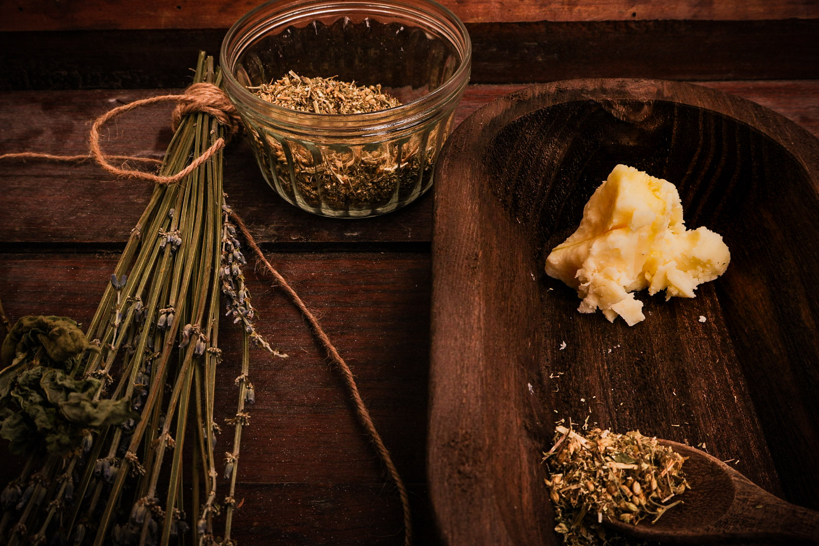 Front Porch Remedy whipped tallow balm ingredients — lavender, thyme, yarrow and tallow on wood