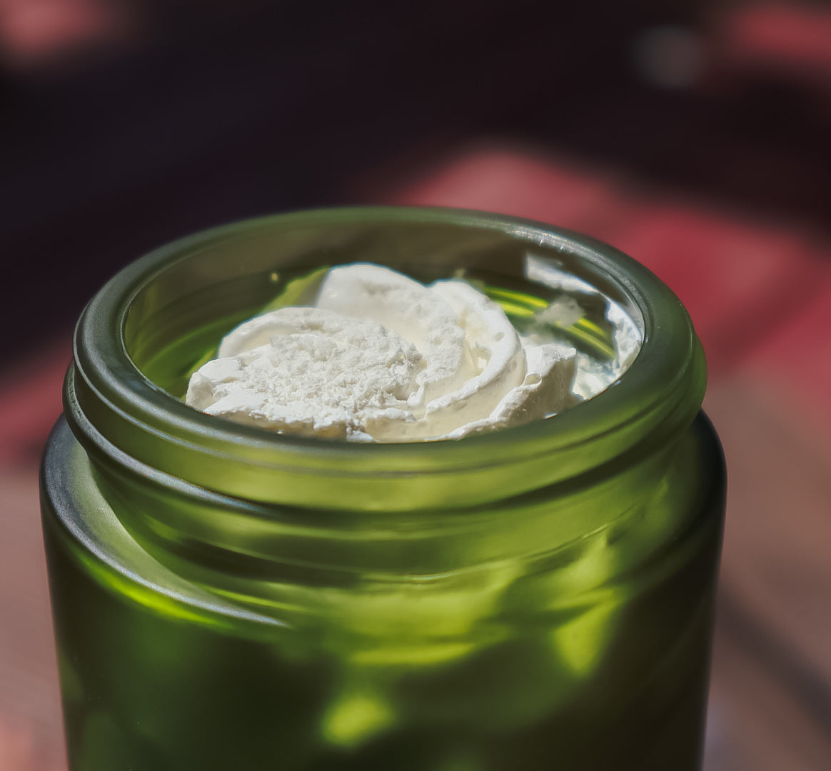 Sun-Keeper tallow sun balm in a green frosted glass jar