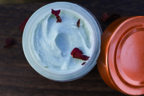 Copper Moon tallow cream open jar with rose petals, overhead view