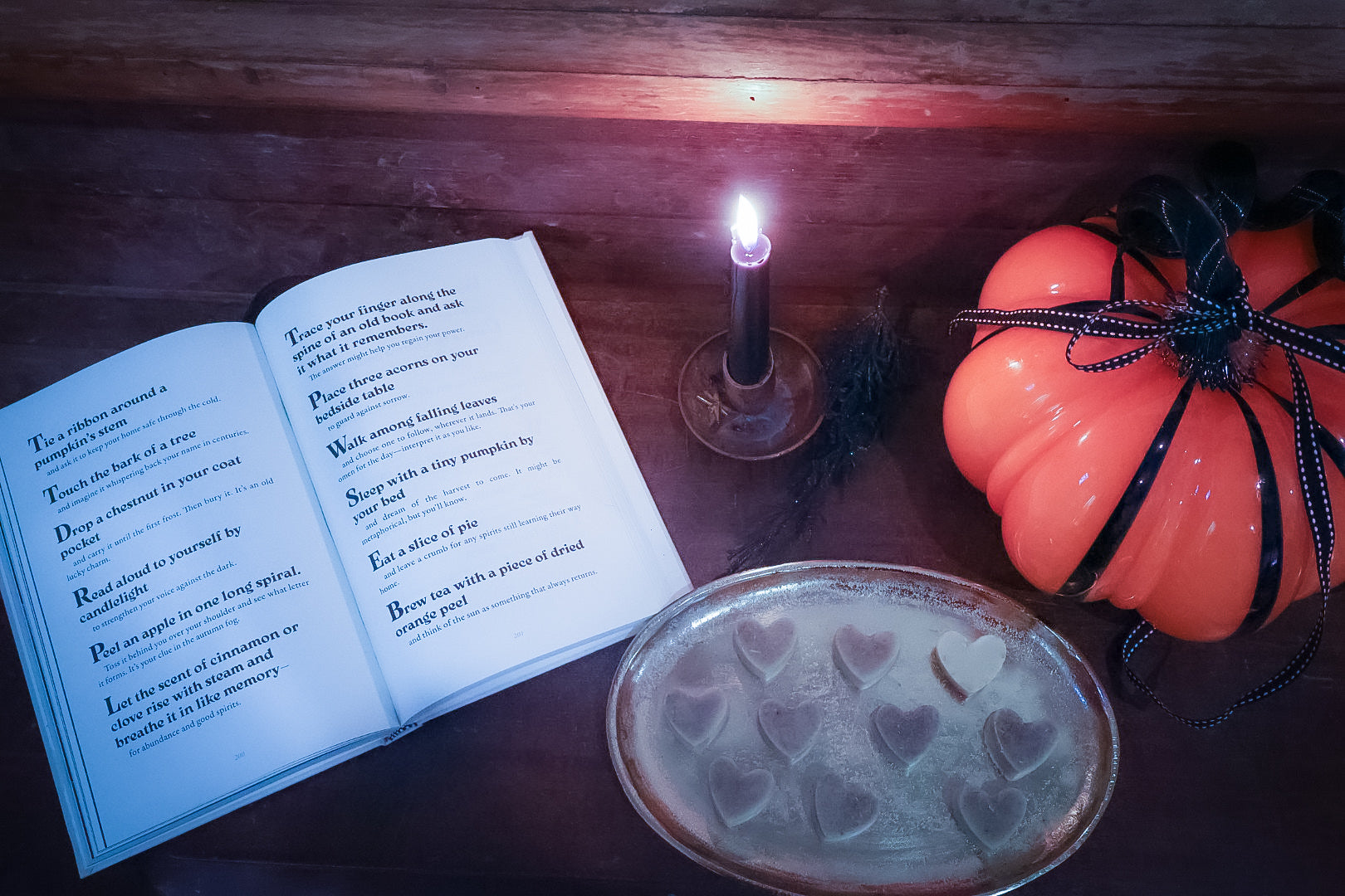 October Fog bath melts by candlelight with open book and ceramic pumpkin