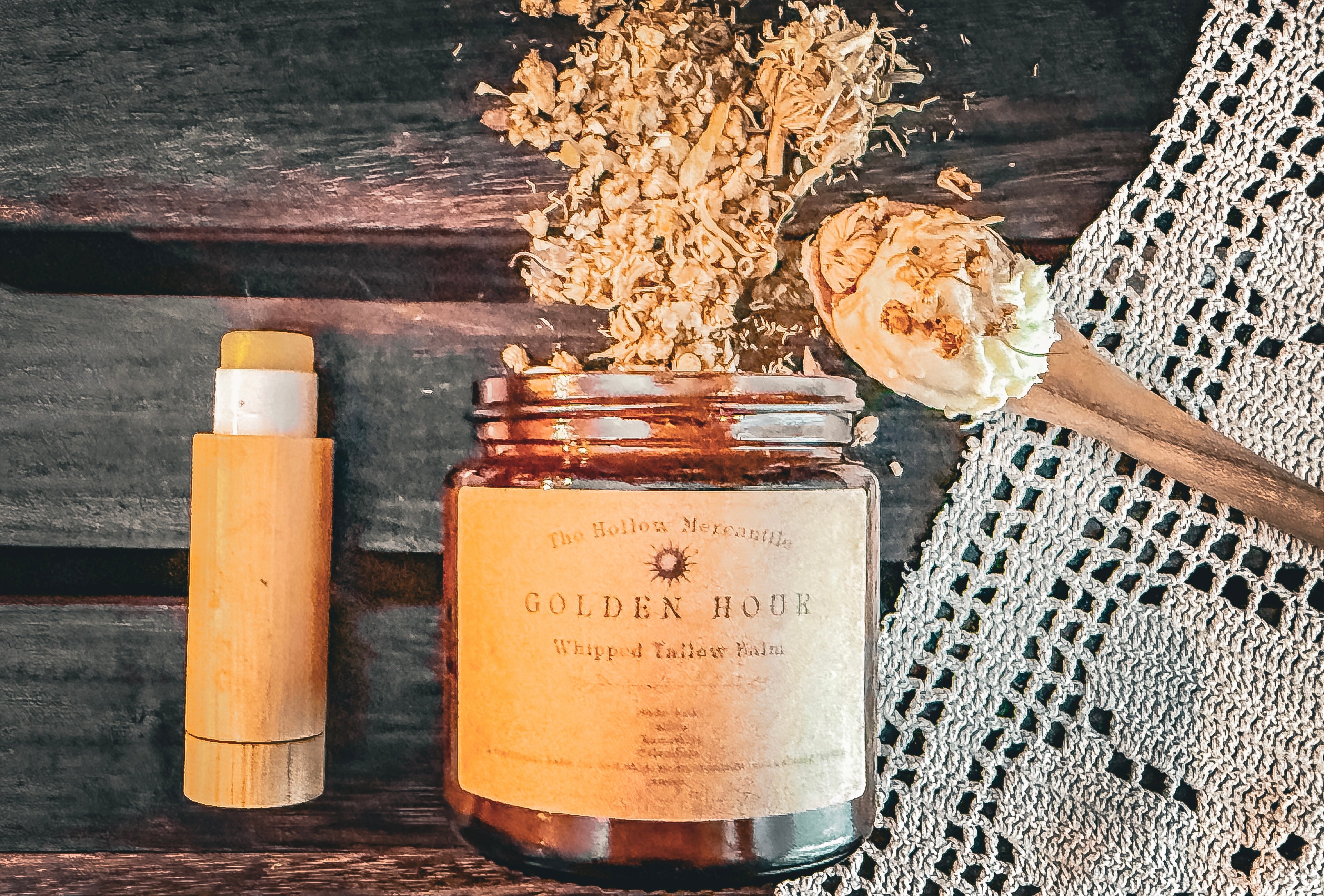 Golden Hour collection — salve stick beside whipped tallow balm jar with dried botanicals